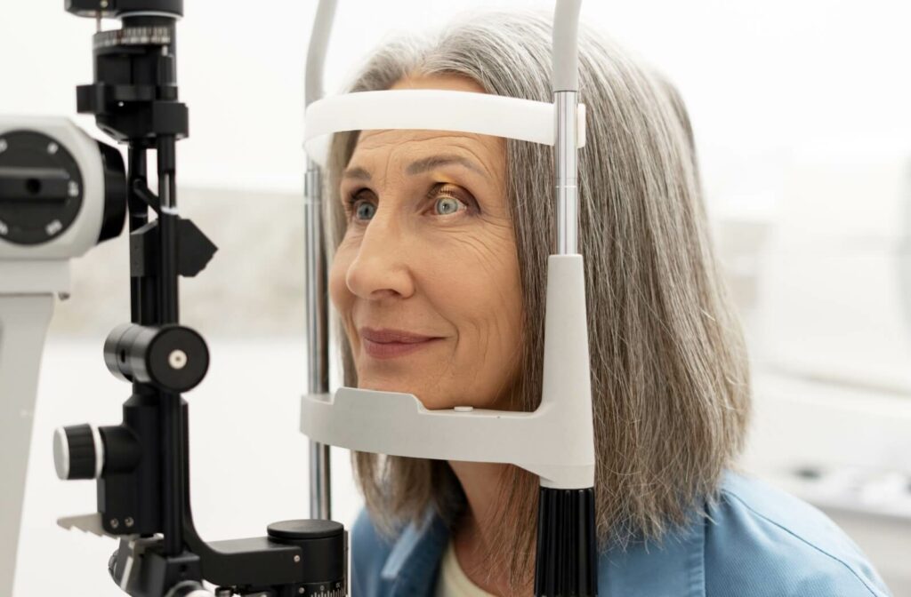 An older adult having a slit lamp examination to check their corneas during their routine eye exam.